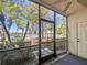 Screened porch with a fan offering a view of the lush landscaping and lake at 238 Cape Harbour Loop # 104, Bradenton, FL 34212