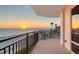 Balcony offering views of the ocean, beach, and community pool, with the sunset as a scenic backdrop at 2525 Gulf Of Mexico Dr # 3F, Longboat Key, FL 34228