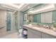 This bathroom features marble countertops and floors, updated fixtures, and a tiled glass-enclosed shower at 2525 Gulf Of Mexico Dr # 3F, Longboat Key, FL 34228