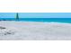 Scenic beach with white sand, turquoise water, and a sailboat, offering a tranquil and picturesque coastal view at 2525 Gulf Of Mexico Dr # 3F, Longboat Key, FL 34228