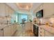 Modern kitchen with stylish countertops and light wood cabinets; dining area and ocean views beyond at 2525 Gulf Of Mexico Dr # 3F, Longboat Key, FL 34228