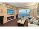 This bright living room has custom built-ins, TV, fireplace, and a large picture window with beach views at 2525 Gulf Of Mexico Dr # 3F, Longboat Key, FL 34228