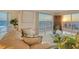 Living room with ocean view at sunset, offering a relaxing ambiance enhanced by natural light and modern decor at 2525 Gulf Of Mexico Dr # 3F, Longboat Key, FL 34228