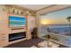 This bright living room has custom built-ins, TV, fireplace, and a large picture window with beach views at 2525 Gulf Of Mexico Dr # 3F, Longboat Key, FL 34228