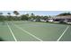 Well-maintained tennis court with green surface, complete with net, fencing, and nearby parking at 2525 Gulf Of Mexico Dr # 3F, Longboat Key, FL 34228