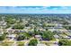 Expansive aerial view showcasing the neighborhood's lush greenery and the surrounding residential landscape at 2538 Lakeshore Cir, Port Charlotte, FL 33952