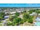 Expansive aerial view showcases the vibrant neighborhood with lush greenery and clear blue skies at 2538 Lakeshore Cir, Port Charlotte, FL 33952