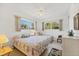 Bright bedroom featuring two beds, natural light, and a ceiling fan at 2538 Lakeshore Cir, Port Charlotte, FL 33952