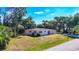 A charming single-story home featuring a well-maintained lawn and lush greenery, providing a serene curb appeal at 2538 Lakeshore Cir, Port Charlotte, FL 33952