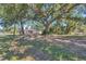 Charming home nestled beneath mature trees, offering shade and curb appeal at 2538 Lakeshore Cir, Port Charlotte, FL 33952