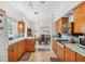 Bright eat-in kitchen featuring wood cabinets and view into the dining room at 2538 Lakeshore Cir, Port Charlotte, FL 33952