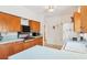 Cozy kitchen featuring bright countertops, wood cabinets, and a ceiling fan at 2538 Lakeshore Cir, Port Charlotte, FL 33952