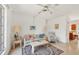 Bright living room featuring terrazzo flooring, floral furnishings, and lots of natural light, creating a cheerful ambiance at 2538 Lakeshore Cir, Port Charlotte, FL 33952