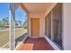 Inviting front porch with tiled flooring and decorative ironwork, offering a charming welcome to the home at 2538 Lakeshore Cir, Port Charlotte, FL 33952