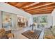 Light filled sunroom with a wood ceiling and views into the eat-in kitchen at 2538 Lakeshore Cir, Port Charlotte, FL 33952