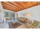 Bright sunroom with a wood ceiling, tile floor, and large windows overlooking the yard at 2538 Lakeshore Cir, Port Charlotte, FL 33952