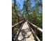 Community boardwalk with handrails winding through native landscape and mature shade trees at 2715 Terra Ceia Bay Blvd # 504, Palmetto, FL 34221