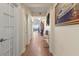 Well-lit hallway with wood floors, neutral walls, artwork, and views to the living space at 2715 Terra Ceia Bay Blvd # 504, Palmetto, FL 34221