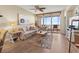 Cozy living room with comfortable seating, wood floors, and access to a screened-in balcony at 2715 Terra Ceia Bay Blvd # 504, Palmetto, FL 34221