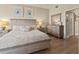 Bright main bedroom featuring a wood-look floor, dresser and mirror, with a doorway to a walk-in closet at 2715 Terra Ceia Bay Blvd # 504, Palmetto, FL 34221