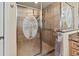 Close-up of the walk-in shower featuring decorative etching on the glass and neutral-toned tiles at 2715 Terra Ceia Bay Blvd # 504, Palmetto, FL 34221