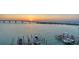 Aerial view of waterfront property, featuring boat docks and a bridge in the distance at 280 Golden Gate Pt # 600, Sarasota, FL 34236