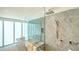 The primary bathroom features a glass shower, a rainfall showerhead, and soaking tub at 280 Golden Gate Pt # 600, Sarasota, FL 34236