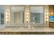 Marble bathroom with dual sinks and a built-in television for elevated morning routines at 280 Golden Gate Pt # 600, Sarasota, FL 34236