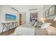 Modern bedroom featuring a TV, stylish console table, and a doorway to an adjoining room at 280 Golden Gate Pt # 600, Sarasota, FL 34236