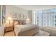 Bright bedroom with a large window, hardwood floors, and neutral-toned decor at 280 Golden Gate Pt # 600, Sarasota, FL 34236