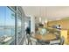 Stylish dining room with waterfront views, contemporary chandelier, and seating for eight at 280 Golden Gate Pt # 600, Sarasota, FL 34236