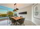 Contemporary dining room with sleek lighting fixtures and large windows overlooking city views at 280 Golden Gate Pt # 600, Sarasota, FL 34236