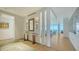 Bright entryway featuring marble table, wood floors, and serene decor at 280 Golden Gate Pt # 600, Sarasota, FL 34236