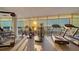 Well-equipped gym with floor-to-ceiling windows and stunning water views at 280 Golden Gate Pt # 600, Sarasota, FL 34236