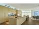 Open concept kitchen features a large center island, ample cabinet space, and modern fixtures at 280 Golden Gate Pt # 600, Sarasota, FL 34236