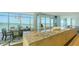 Modern kitchen with large island, stainless steel appliances, and scenic waterfront views at 280 Golden Gate Pt # 600, Sarasota, FL 34236