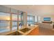 Gourmet kitchen features granite counters, modern appliances, and stunning water views from expansive windows at 280 Golden Gate Pt # 600, Sarasota, FL 34236