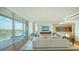 Spacious living room with waterfront view, expansive windows, and sleek furniture at 280 Golden Gate Pt # 600, Sarasota, FL 34236