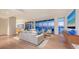 Bright and airy living room with floor to ceiling windows and beautiful water view at 280 Golden Gate Pt # 600, Sarasota, FL 34236