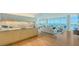 Contemporary living room featuring stunning water views, wood floors and sleek kitchenette at 280 Golden Gate Pt # 600, Sarasota, FL 34236
