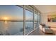 Comfortable living room showcasing floor-to-ceiling windows with water view at 280 Golden Gate Pt # 600, Sarasota, FL 34236