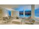 Stylish lounge area featuring modern furniture, sleek decor, and breathtaking marina views at twilight at 280 Golden Gate Pt # 600, Sarasota, FL 34236