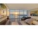 Main bedroom showcasing large windows with sunrise waterfront views at 280 Golden Gate Pt # 600, Sarasota, FL 34236