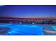 Stunning twilight view of the illuminated pool overlooking the tranquil harbor and distant bridge at 280 Golden Gate Pt # 600, Sarasota, FL 34236