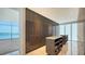 Elegant walk-in closet with custom cabinetry, center islands, and water views at 280 Golden Gate Pt # 600, Sarasota, FL 34236