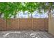 A backyard featuring a stone wall, brick-paver patio and shade trees at 288 Crew Ct, Sarasota, FL 34243