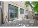 Backyard features a brick-paver patio, AC unit and mature shade trees at 288 Crew Ct, Sarasota, FL 34243
