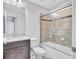 Bathroom featuring dark vanity, and tiled shower with glass doors and granite countertop at 288 Crew Ct, Sarasota, FL 34243
