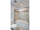 Cozy bathroom featuring a bathtub with tiled shower and a white toilet seat at 288 Crew Ct, Sarasota, FL 34243