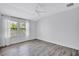 Bright bedroom with new hardwood floors, updated window and modern ceiling fan at 288 Crew Ct, Sarasota, FL 34243